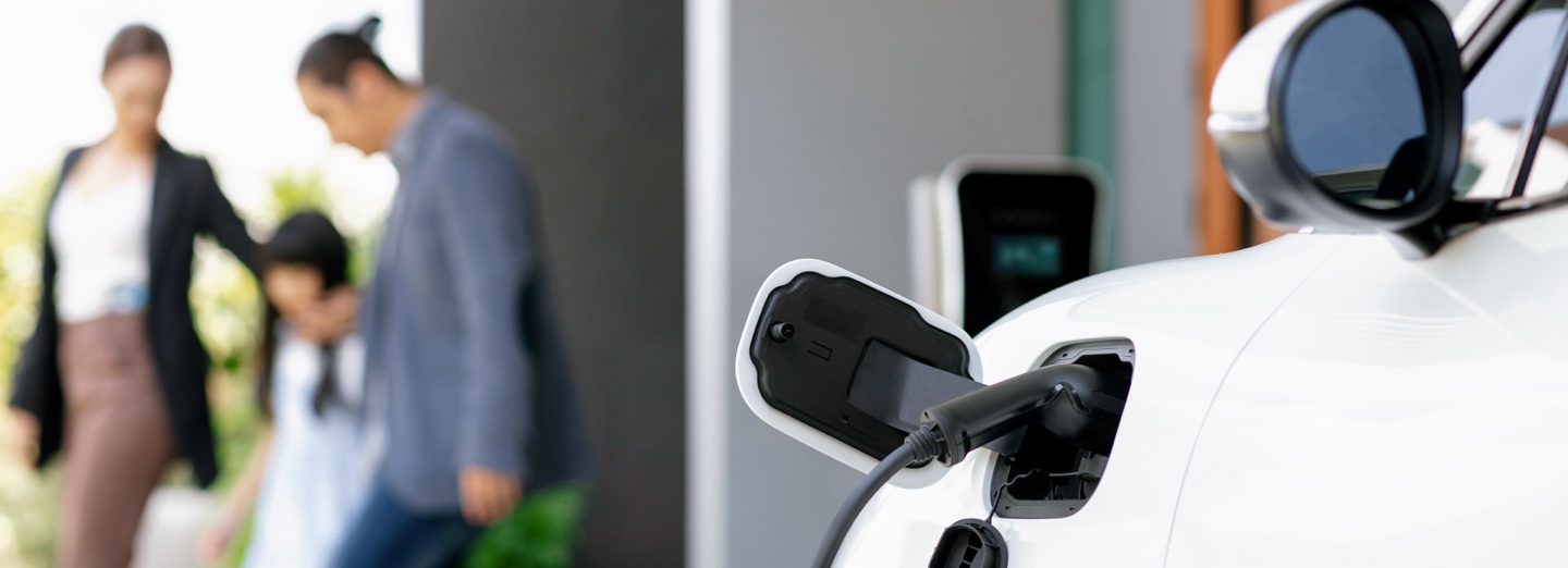 EV charging with family in background